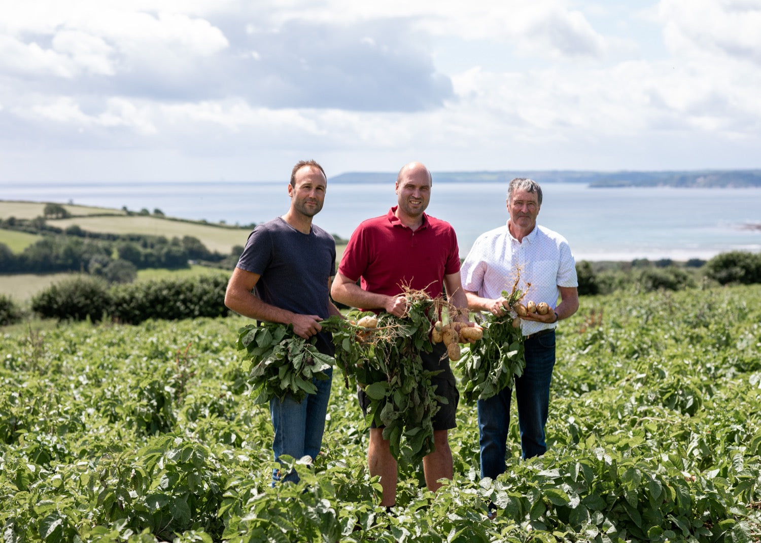 The Dustow family with freshly lifted potatoes in their Cornish fields